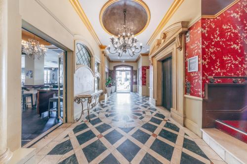an ornate hallway with a chandelier and a lobby at Maze Backpackers - Gold Coast in Gold Coast