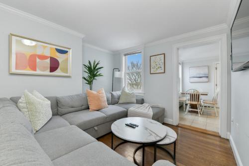 a living room with a couch and a table at The Princeton Boston Luxurious Apartment - New! - Near Downtown Boston, Airport in Boston