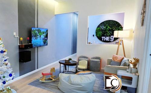 a living room with a christmas tree in the corner at Skudai - The 9 Homestay near UTM, Kangkar Pulai in Skudai