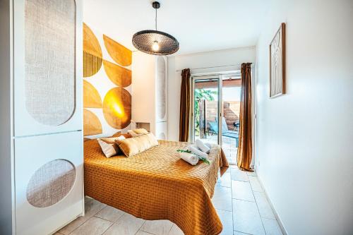 a bedroom with a bed in a room with a window at Appartement T4 - Villa Les Bougainvilliers in Les Trois-Îlets