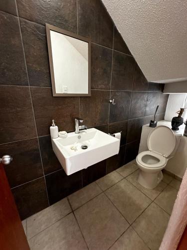 a bathroom with a sink and a toilet at Casa de Lucas in Balvanera
