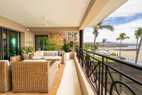 a balcony with wicker furniture and a view of the beach at Hacienda De Mita, Close to Ocean and Golf in Punta Mita
