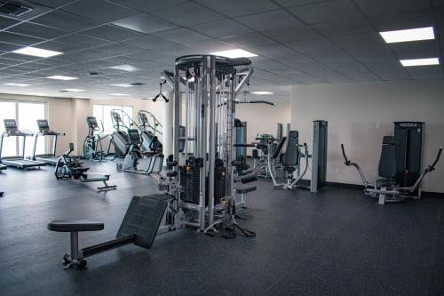 a gym with several treadmills and exercise bikes at Sunset Caribe Belize in San Pedro