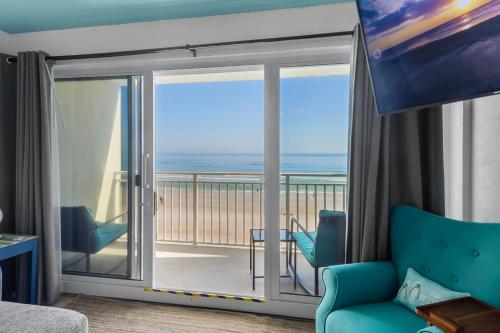 a living room with a view of the ocean at Ocean Front and Pool Front At Daytona Inn Beach Resort in Daytona Beach