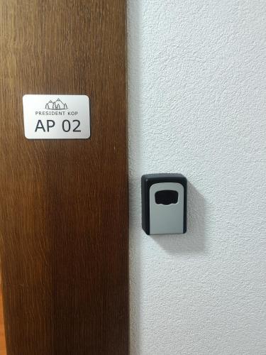 a door with a sign on it next to a wall at Apartman Alastra AP 02 President Kop in Kopaonik