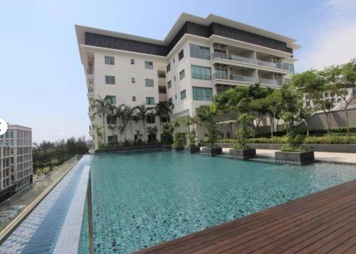 a swimming pool in front of a building at Imago Loft Residences - By The Pool in Kota Kinabalu