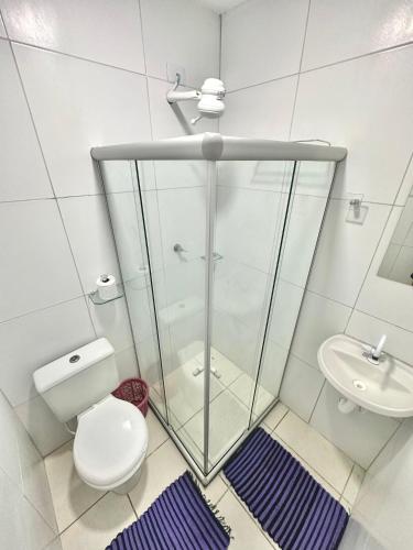 a bathroom with a shower and a toilet and a sink at Quarto 02 - Pousada Canaã in Recife