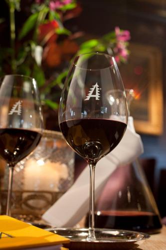 two glasses of red wine sitting on a table at Waldhaus Ohlenbach in Schmallenberg