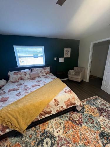 a bedroom with a large bed and a window at The Suite Picasso in Deltona