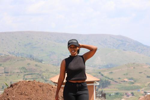 a woman standing on top of a mountain at MUPENDA TOURIST APARTMENTs in Kabale