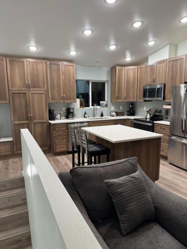 a kitchen with wooden cabinets and a table and chairs at City Retreat, 2bdrm near Airport in Anchorage