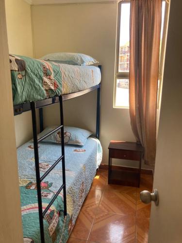 two bunk beds in a room with a window at D11-4 Depto diario Arica in Arica