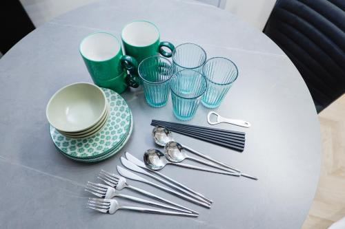 a table with plates and forks and cups and spoons at Ra Grande by Tranova in Tokyo
