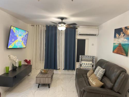 a living room with a couch and a table at Jamrock Place in Montego Bay
