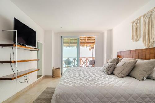 Un dormitorio con una cama grande y un televisor. en 3BR Apt in Acapulco with Pool and Private Club, en Acapulco