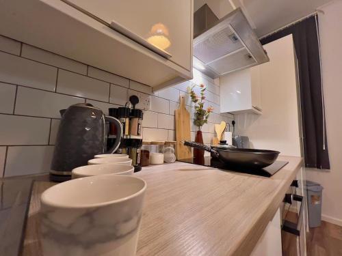 a kitchen with a counter top with a cup on it at Stunning 2BR Apt - City Centre - Sleeps 6 - Parking - 5g WiFi in Midland