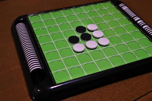 a chess board with four green and black pieces at The83C in Takaoka