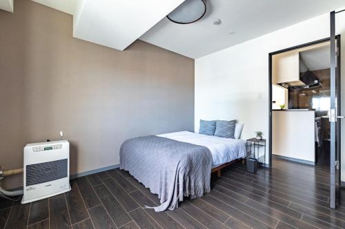 a bedroom with a bed and a large mirror at Cozy Stay Sapporo Hongodori 405 in Sapporo