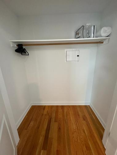 an empty room with a shelf on the wall at Luxury Gated NYC Theme 3BR 2B with Parking by EWR in Elizabeth