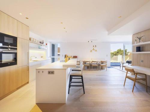 une cuisine avec des appareils électroménagers blancs et une salle à manger dans l'établissement Appartement de Prestige au Touquet avec Wifi et Parking - FR-1-821-15, à Le Touquet-Paris-Plage