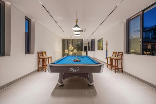 a pool table in the middle of a room at The Paradise Pool House Since 2025 in Da Nang