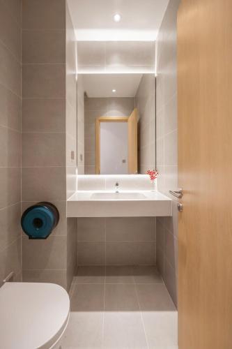a bathroom with a sink and a toilet and a mirror at The Paradise Pool House Since 2025 in Da Nang