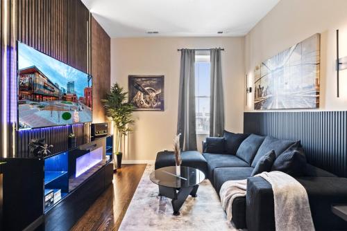 a living room with a couch and a tv at Soulard Suite in Saint Louis
