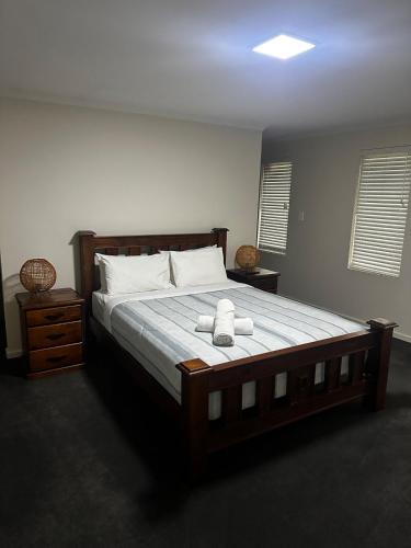 a bedroom with a large bed with two towels on it at Shore Beats Workin in Esperance