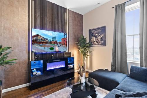 a living room with a blue couch and a flat screen tv at Soulard Suite in Saint Louis