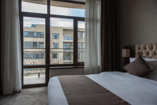 Postel nebo postele na pokoji v ubytování Hotel FN Shymkent