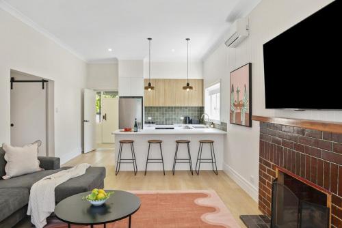 a living room with a couch and a fireplace at Wilson House - Central Character Home in Mount Gambier