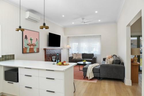 a kitchen and living room with a white counter top at Wilson House - Central Character Home in Mount Gambier