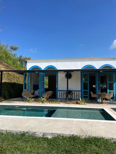 a house with a swimming pool in front of it at Piscina privada in Alcalá