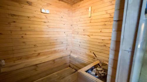 a wooden sauna with a box in the corner at Apartment Borneo Bay City - AH Property Indonesia in Balikpapan