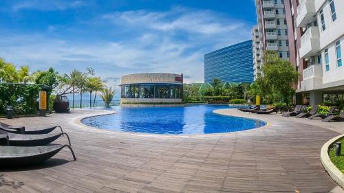 a swimming pool in the middle of a building at Apartment Borneo Bay City - AH Property Indonesia in Balikpapan