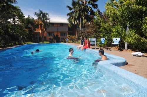 a group of people swimming in a swimming pool at CDU Village Casuarina Campus in Jingili