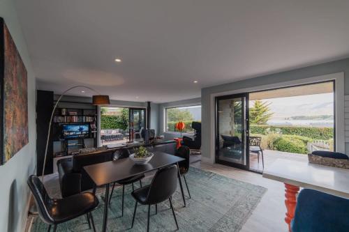 a living room with a table and chairs at 2BR Stay with Fireplace Hot Tub BBQ - Tasman in Lake Tekapo