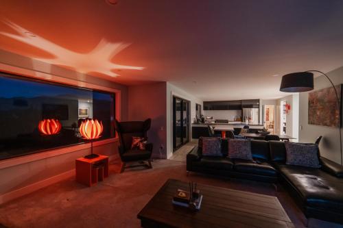 a living room with a couch and a table at 2BR Stay with Fireplace Hot Tub BBQ - Tasman in Lake Tekapo