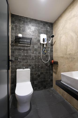 a bathroom with a toilet and a sink at Loft 82 in Bukit Mertajam