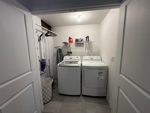 a small kitchen with a stove and a washer and dryer at Brand New 2 story unit in Richmond Hill