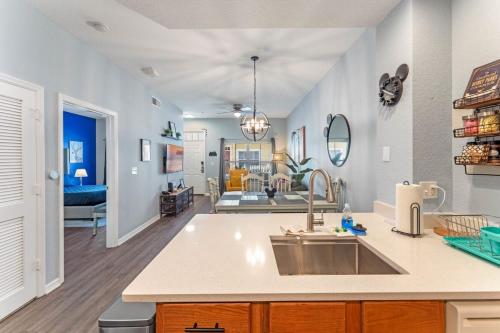 a kitchen with a sink and a living room at 4005 SAN SABASTIAN DRIVE 3BED in Kissimmee