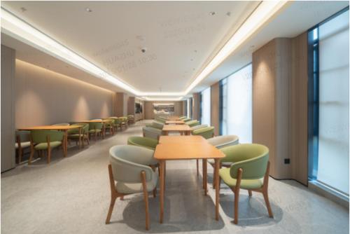 a row of tables and chairs in a room at JI Shanghai International Tourism Liufeng Highway Hotel in Shanghai