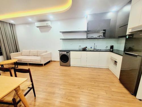 a kitchen and living room with a couch and a table at TC Apartment & Homestay in An Khê