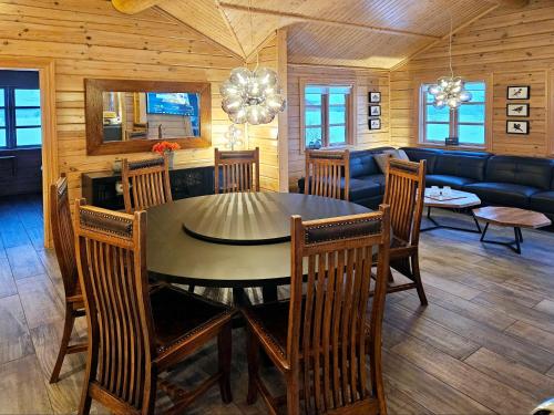 a dining room and living room with a table and chairs at Aurora Vacation Homes Fagravik in Akureyri