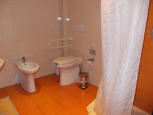a bathroom with a toilet and a sink at Hotel Catania Town in Catania