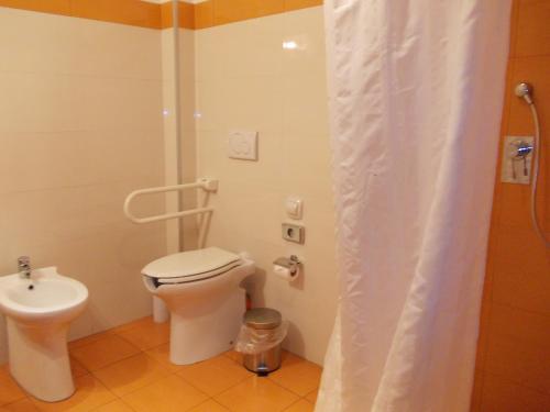 a small bathroom with a toilet and a sink at Hotel Catania Town in Catania