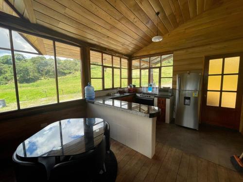 a kitchen in a cabin with a table and some windows at Nodriza House in Baeza