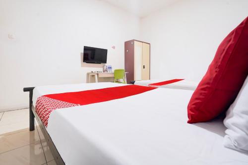 Μια τηλεόραση ή/και κέντρο ψυχαγωγίας στο Hotel O Rappocini Near Rsia Paramount