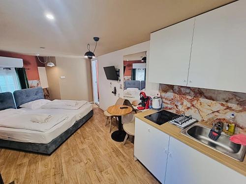 a bedroom with a bed and a kitchen with a sink at Modern Studio N9 Kitchenette Bathroom in Limassol