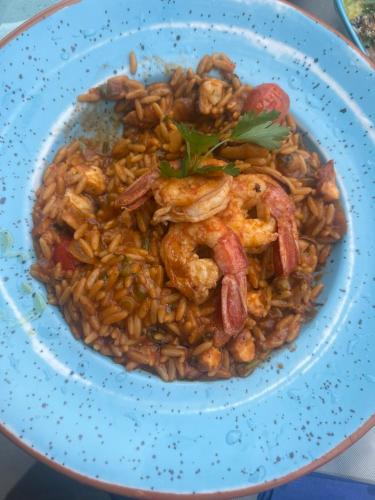 a blue bowl of food with shrimp and rice at yoco in Eleonas